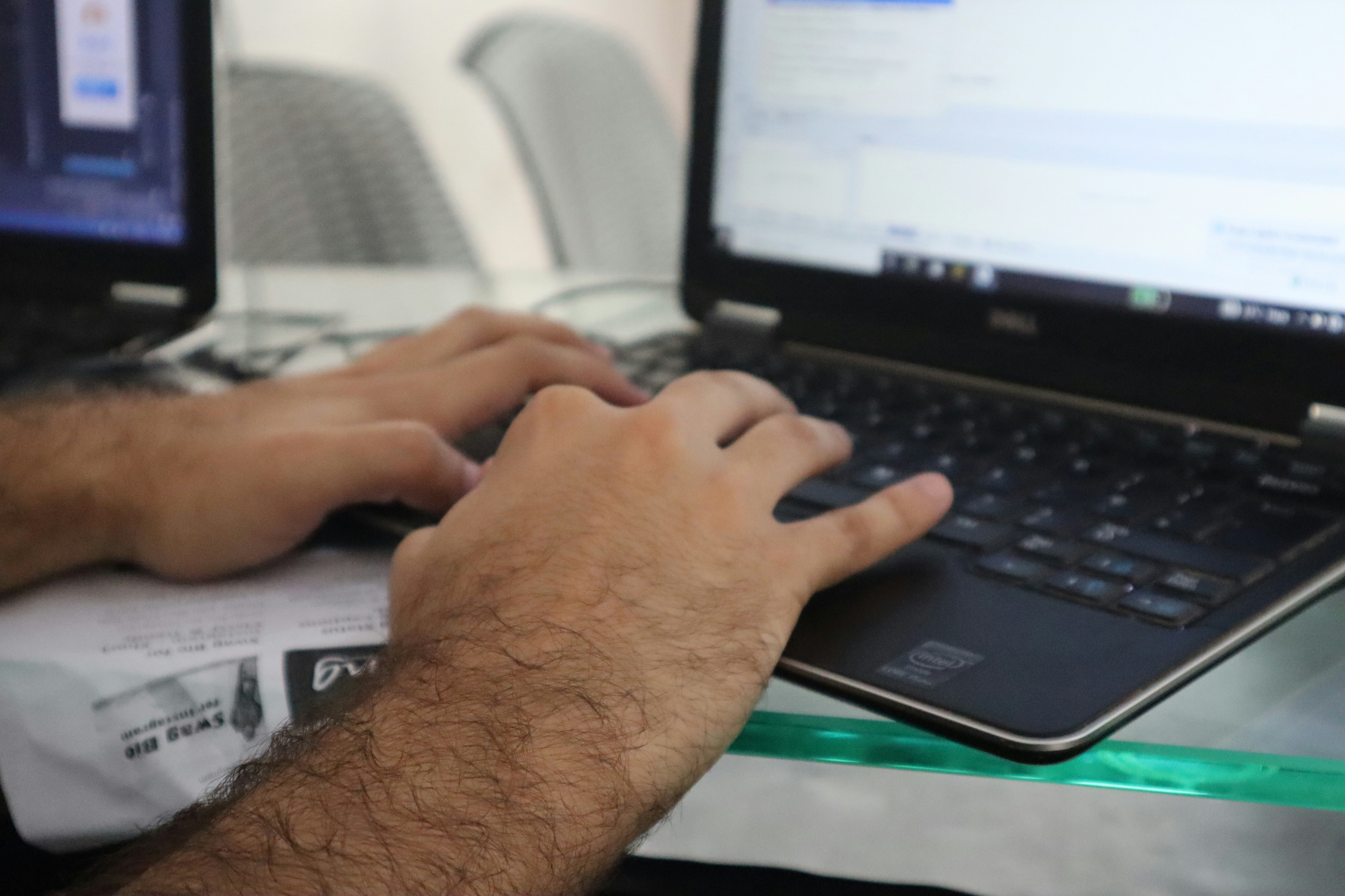 a man is typing on a laptop computer